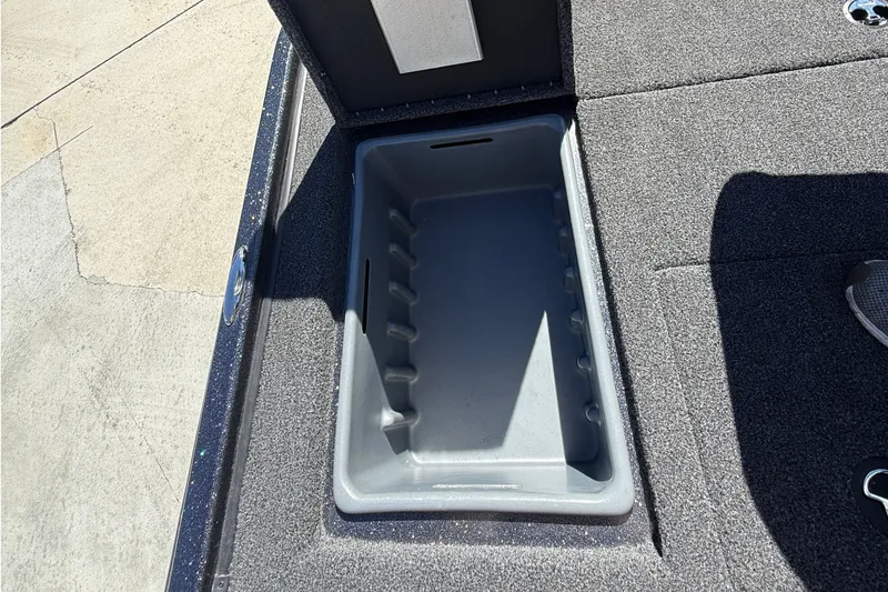 Slide: The Image of Open storage compartment in 2027 Nitro Z20 XL Pro boat, featuring carpeted interior. - 42