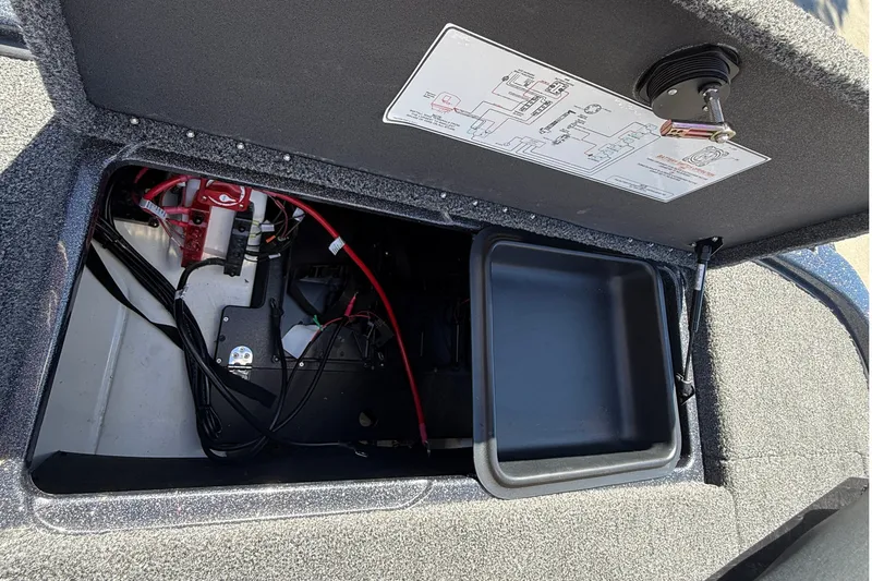 Slide: The Image of Open storage compartment of 2027 Nitro Z20 XL Pro boat, showing wiring and components. - 43