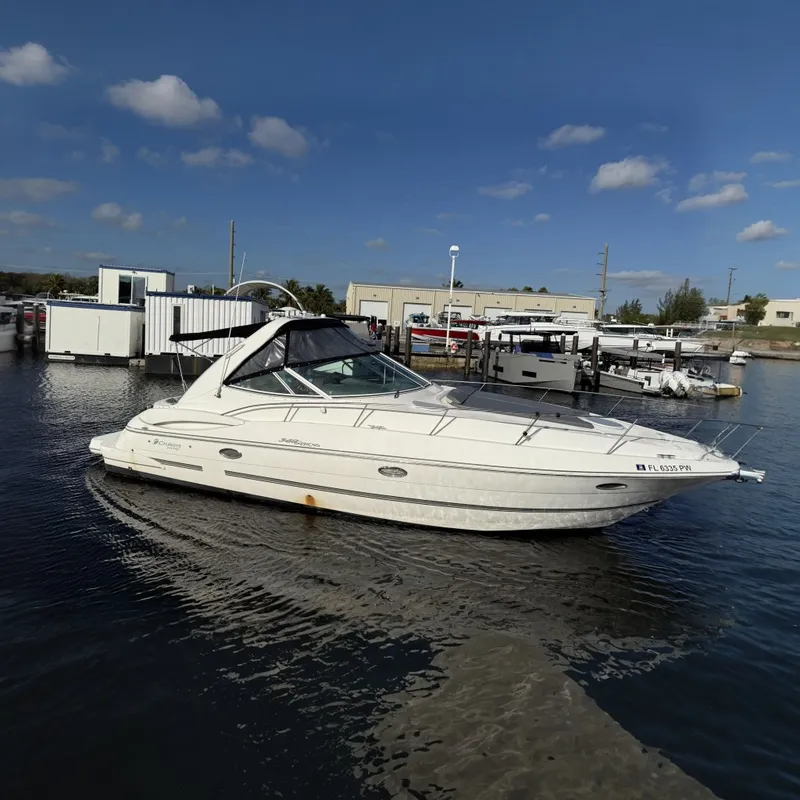 The Image of 2005 Cruisers Yachts 340 Express in marina, clear sky, calm water. - 0