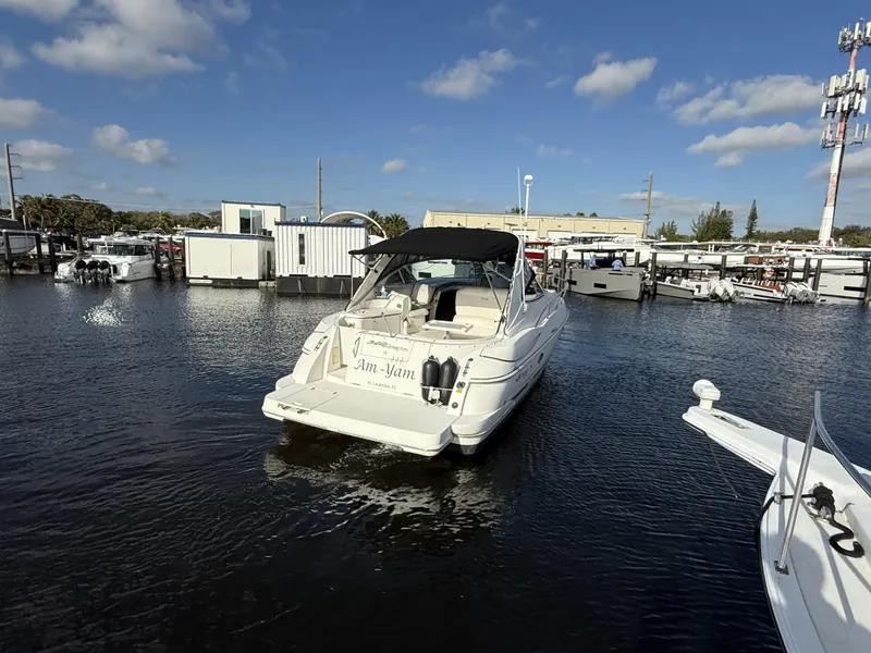 Slide: The Image of 2005 Cruisers Yachts 340 Express docked in a marina under a clear blue sky. - 32