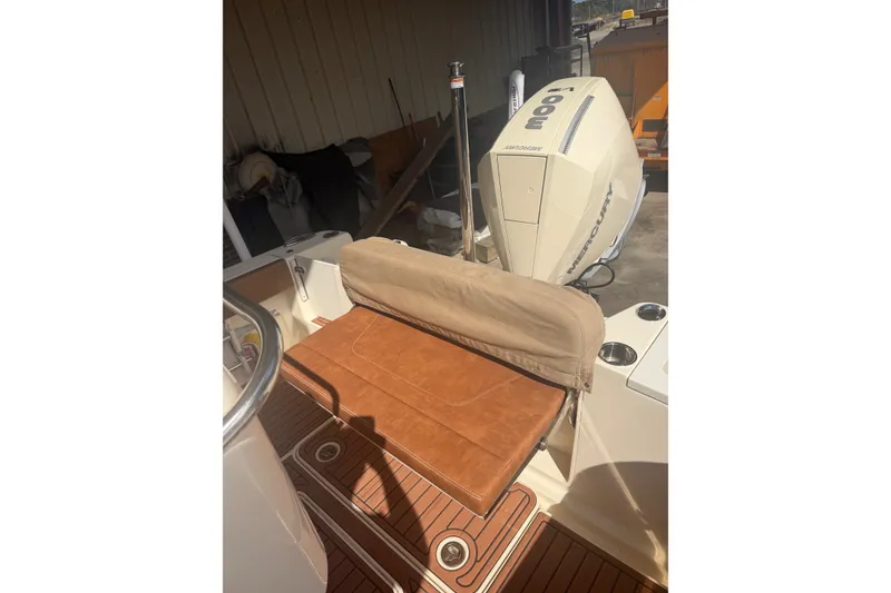 Slide: The Image of 2024 Scout 240 XSF boat with Mercury engine and cushioned seating. - 27