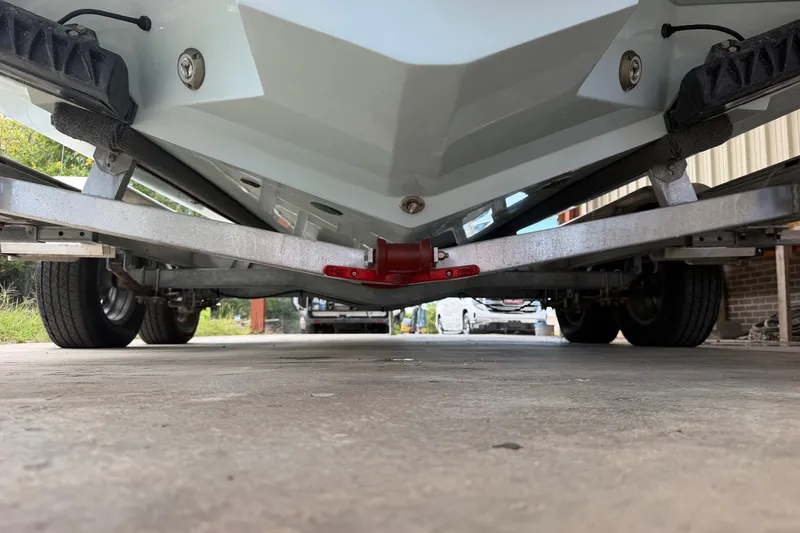 Slide: The Image of Underneath view of a 2024 Scout 240 XSF boat on a trailer. - 48
