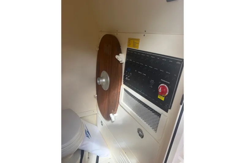 Slide: The Image of 2024 Scout 240 XSF boat interior with control panel and wooden door. - 38
