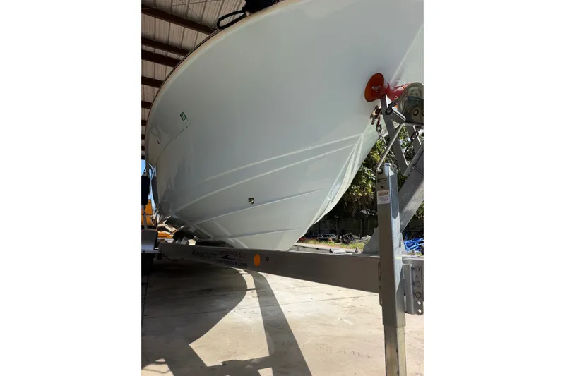 Slide: The Image of 2024 Scout 240 XSF boat on trailer in a covered storage area. - 7
