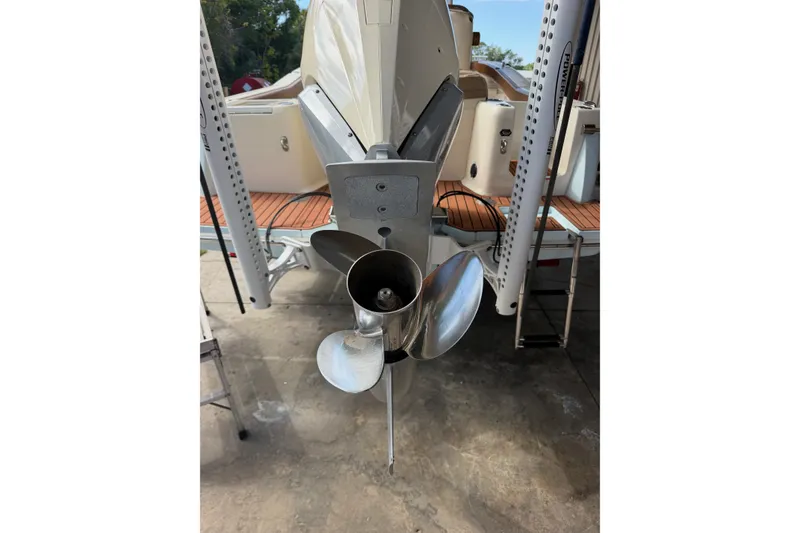 Slide: The Image of 2024 Scout 240 XSF boat propeller and stern view in a marina setting. - 42