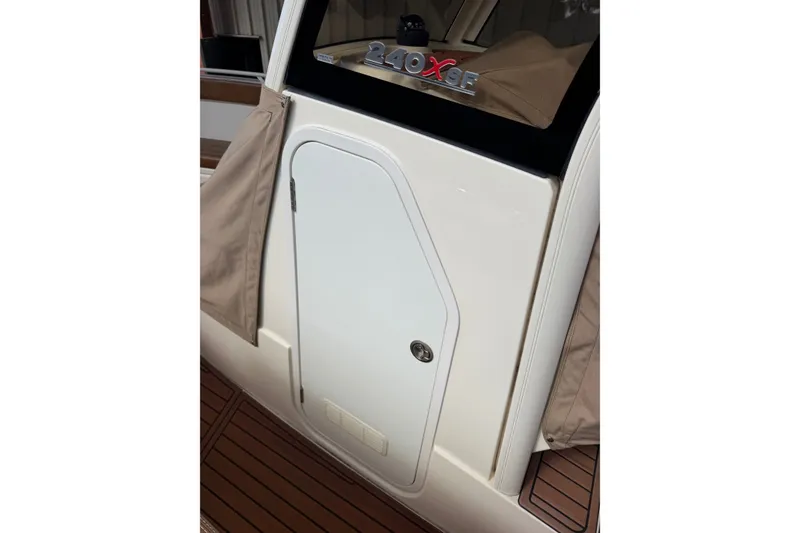 Slide: The Image of 2024 Scout 240 XSF boat cabin door with sleek design and beige cover. - 36
