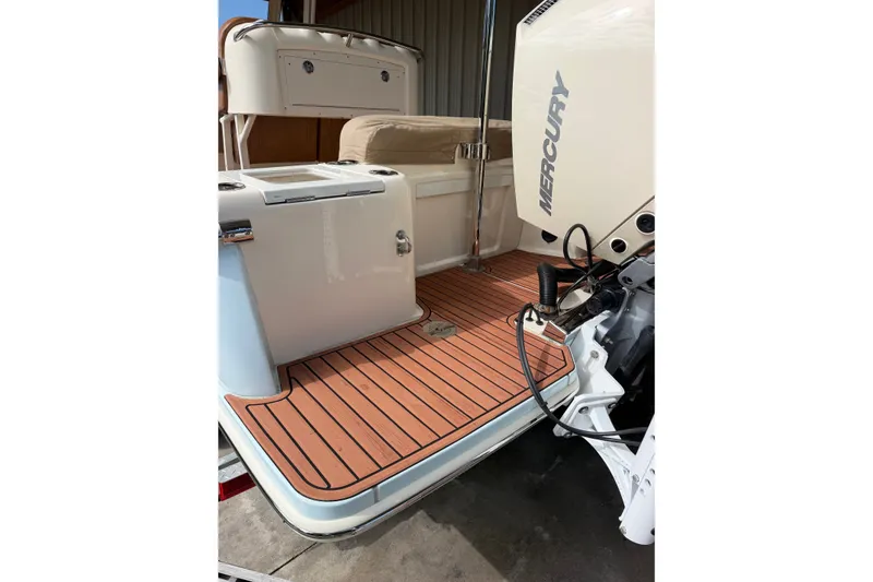 Slide: The Image of 2024 Scout 240 XSF boat with Mercury engine, featuring teak deck flooring. - 40