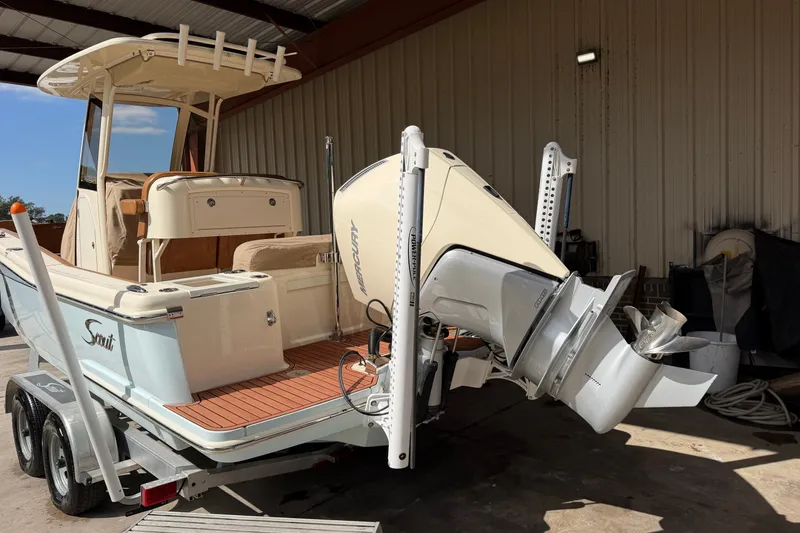 Slide: The Image of 2024 Scout 240 XSF boat on trailer, featuring a powerful Mercury outboard motor. - 5