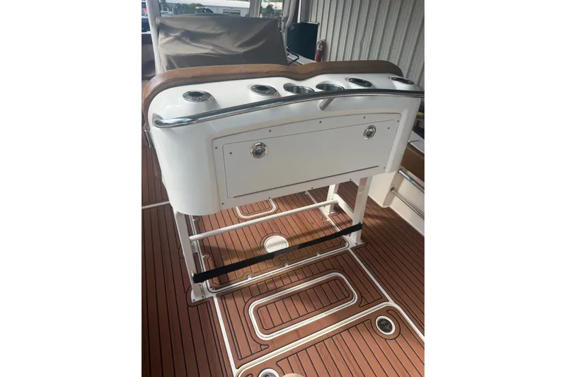 Slide: The Image of 2024 Scout 240 XSF boat interior with cup holders and teak flooring. - 19