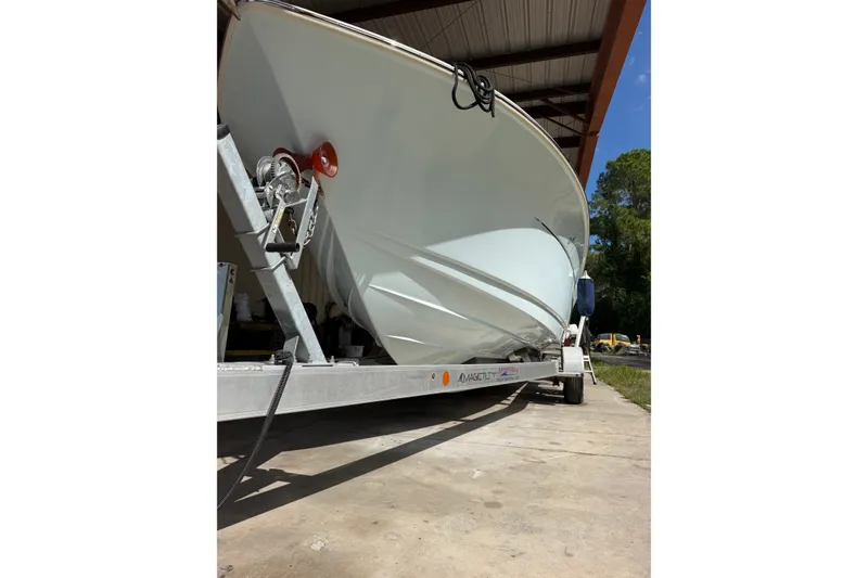 Slide: The Image of 2024 Scout 240 XSF boat on trailer in covered storage area. - 6