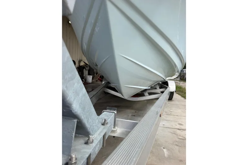 Slide: The Image of 2024 Scout 240 XSF boat on trailer, showcasing sleek hull design. - 51