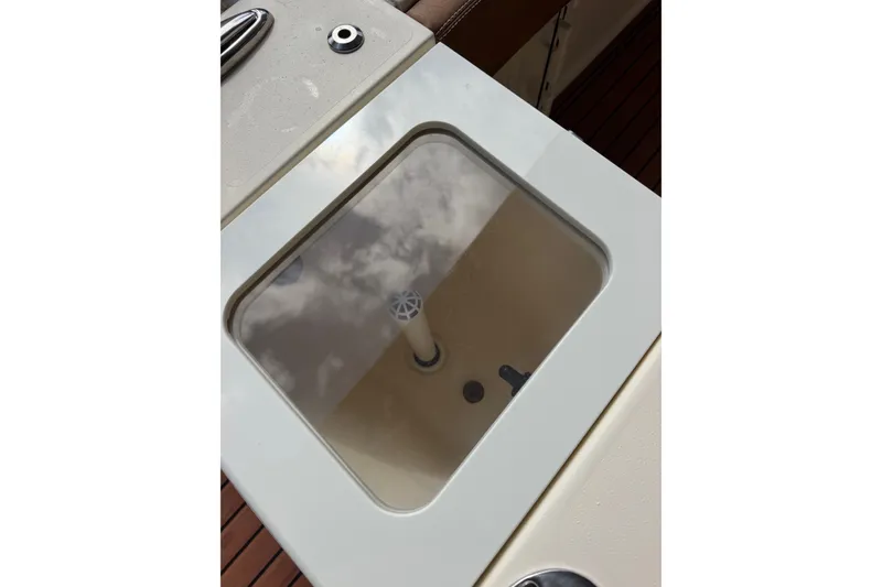 Slide: The Image of Livewell on 2024 Scout 240 XSF boat, featuring a transparent lid and sleek design. - 34