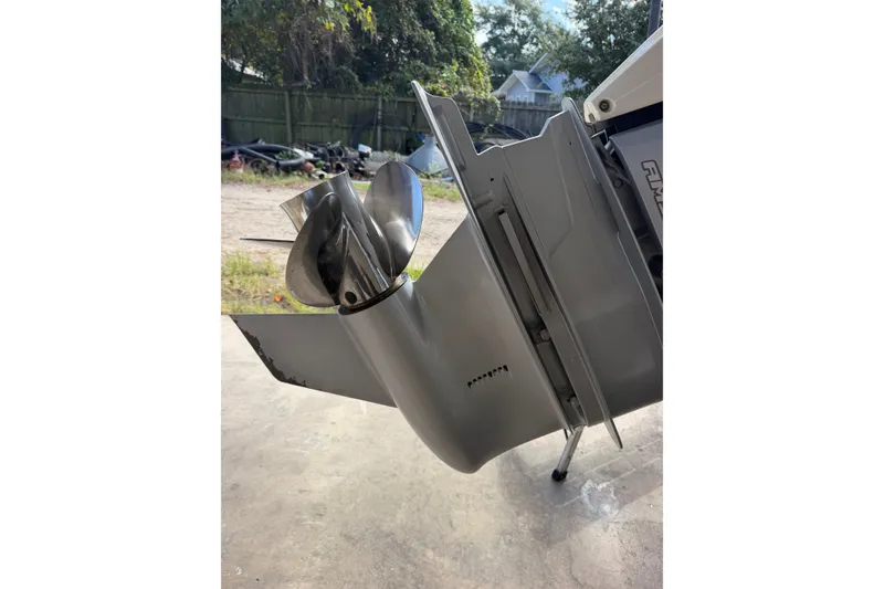 Slide: The Image of 2024 Scout 240 XSF boat propeller and lower unit detail in outdoor setting. - 44