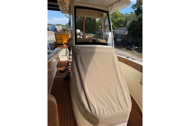 Slide: The Image of 2024 Scout 240 XSF boat with covered console, docked outdoors. - 30
