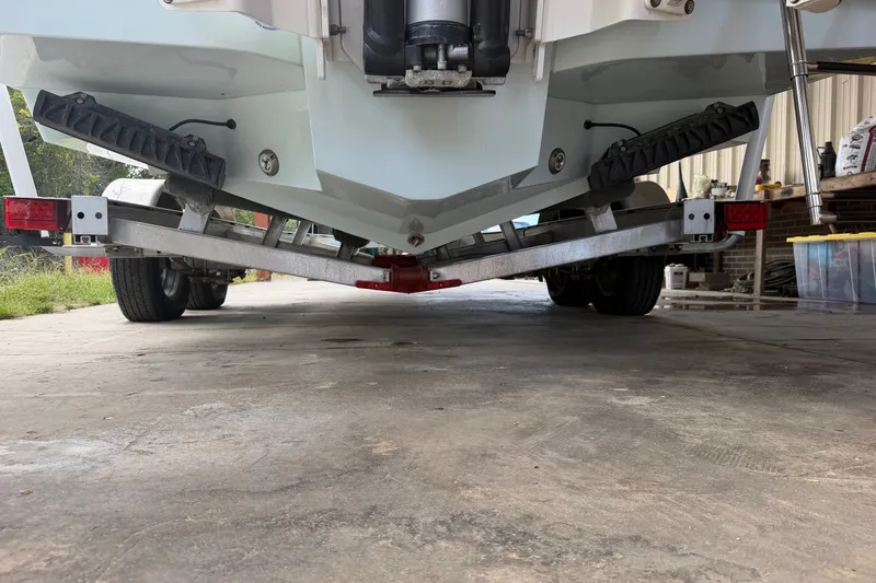 Slide: The Image of 2024 Scout 240 XSF boat on trailer, viewed from rear, showcasing hull and trailer details. - 47