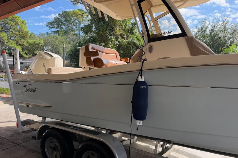 The Image of 2024 Scout 240 XSF boat on trailer, featuring sleek design and comfortable seating. - 0