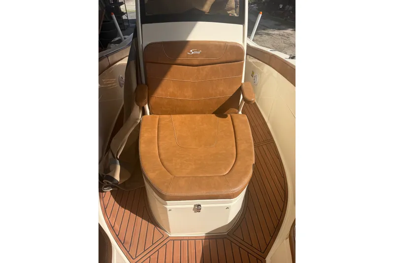 Slide: The Image of Luxurious seating on 2024 Scout 240 XSF boat with brown leather and wood accents. - 32