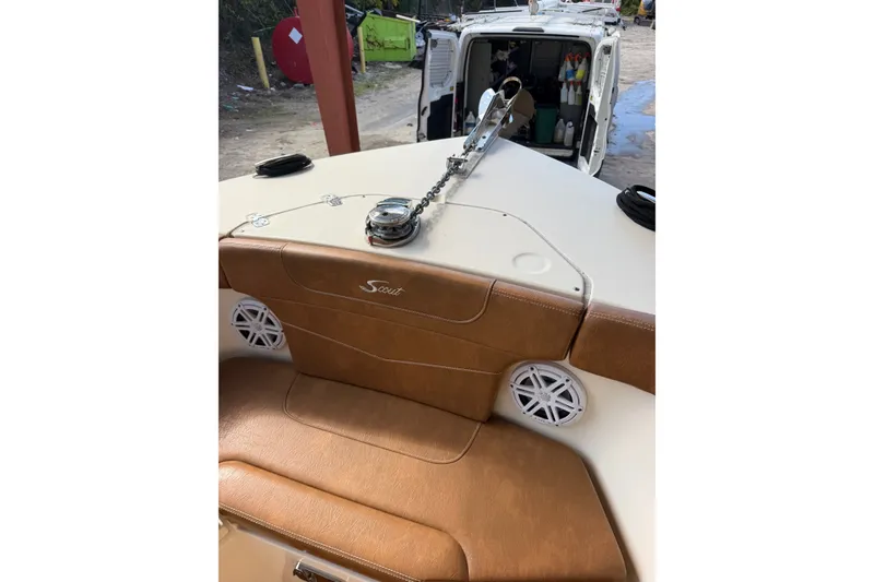 Slide: The Image of 2024 Scout 240 XSF boat interior with tan seating and anchor chain. - 14
