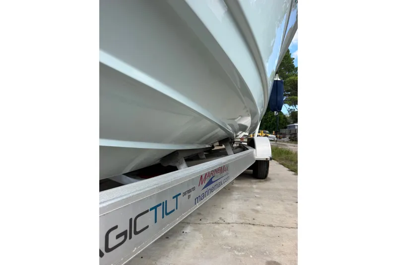 Slide: The Image of 2024 Scout 240 XSF boat on Magic Tilt trailer, side view. - 53