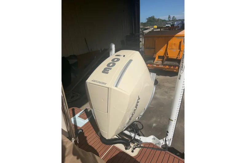 Slide: The Image of 2024 Scout 240 XSF boat with Mercury outboard engine in a dockside setting. - 41