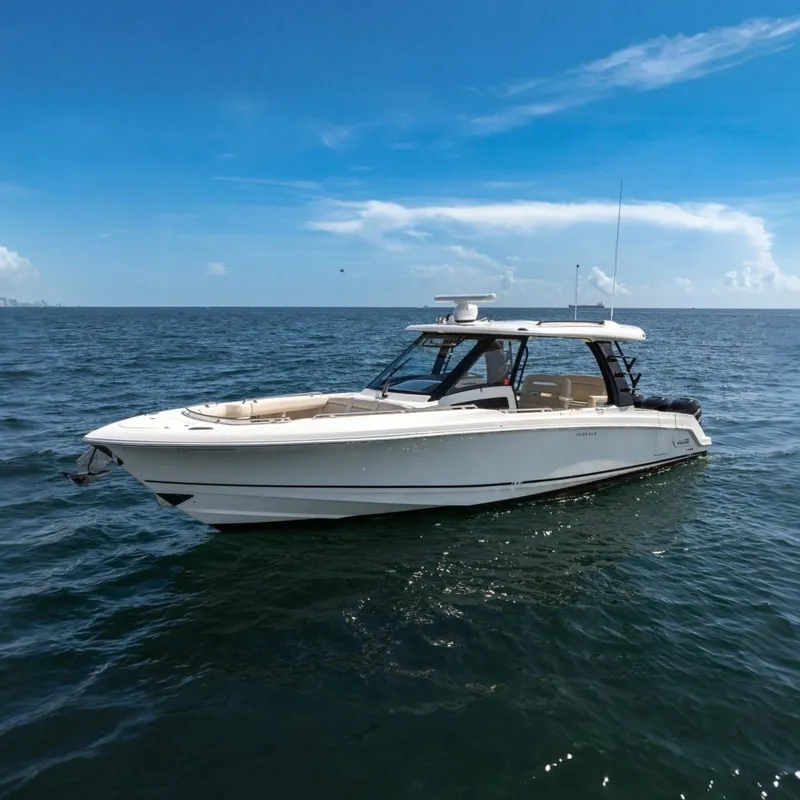 The Image of 2023 Boston Whaler 350 Realm boat on open sea under clear blue sky. - 0