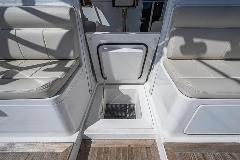 Slide: The Image of 2021 Viking 38 Open boat interior with cushioned seating and storage compartment. - 46