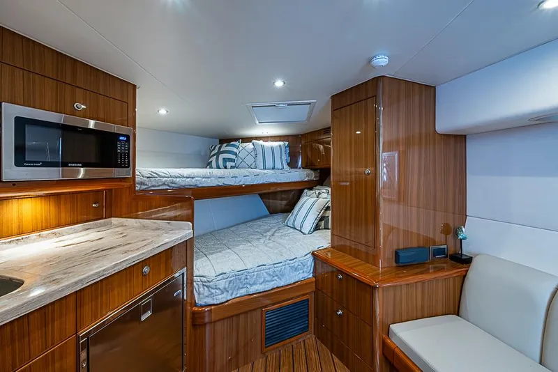 Slide: The Image of Luxurious interior of 2021 Viking 38 Open yacht with modern amenities and cozy sleeping area. - 14