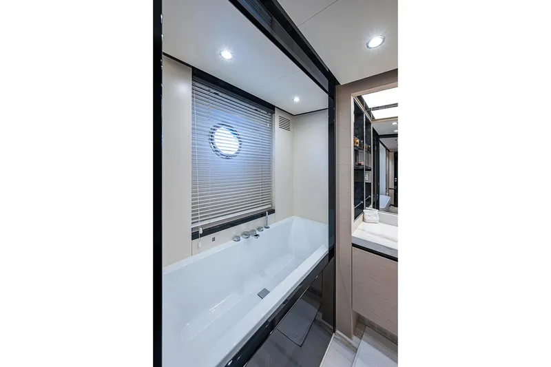 Slide: The Image of Luxurious bathroom interior on 2017 Azimut 80 yacht with modern bathtub and porthole window. - 79