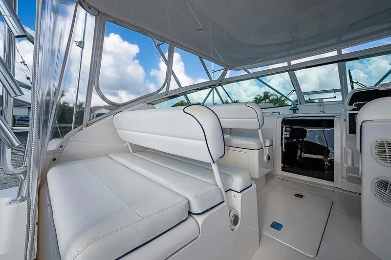 Slide: The Image of Interior of a 2008 Bertram 360 boat with white seating and clear windows. - 45