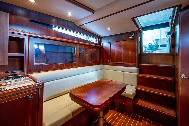 Slide: The Image of Luxurious interior of a 2008 Bertram 360 yacht with wooden finishes and seating area. - 24