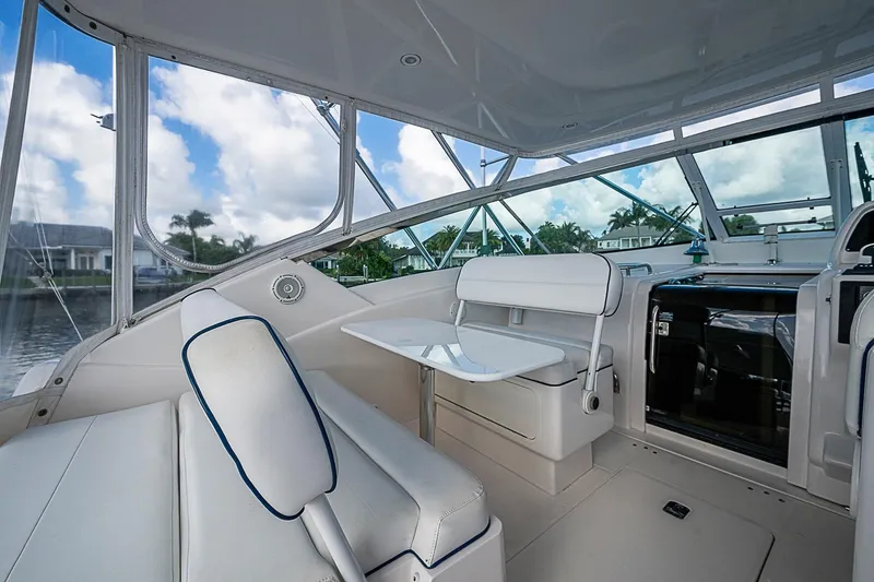 Slide: The Image of 2008 Bertram 360 yacht interior with white seating and table, showcasing luxury design. - 47