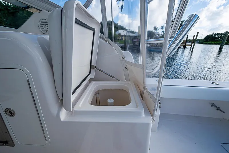 Slide: The Image of Open storage compartment on a 2008 Bertram 360 boat, with water view in the background. - 40