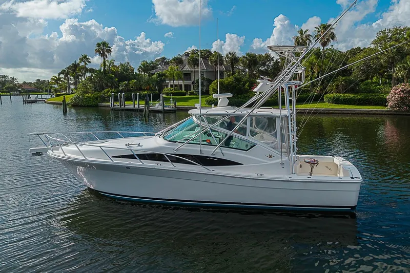 Slide: The Image of 2008 Bertram 360 yacht on a serene waterway, surrounded by lush greenery and clear skies. - 9