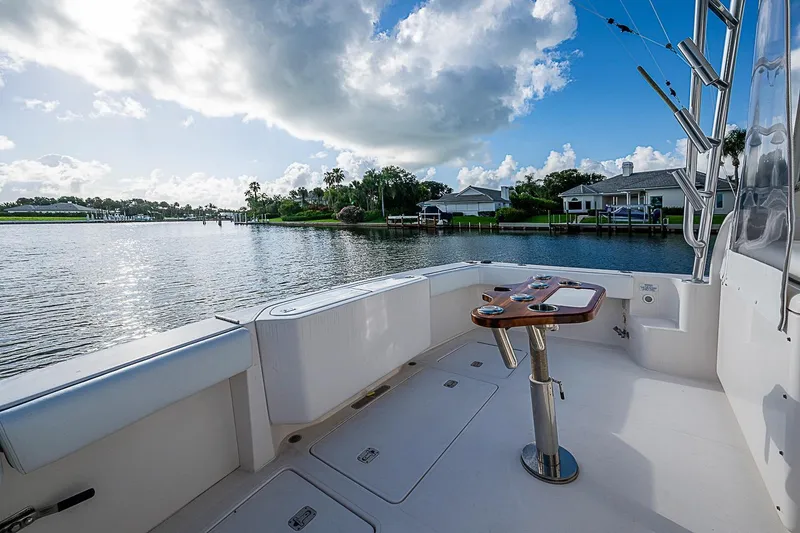 Slide: The Image of 2008 Bertram 360 boat deck overlooking serene waterfront and residential area under a partly cloudy sky. - 29