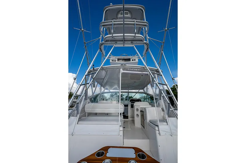 Slide: The Image of 2008 Bertram 360 yacht with tower, sleek design, and spacious cockpit under a clear blue sky. - 34