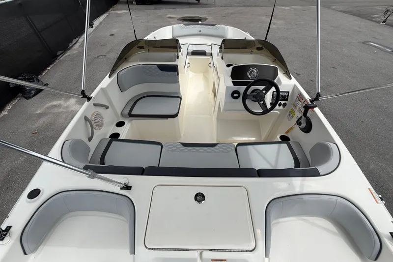 Slide: The Image of 2024 Bayliner Element M17 boat interior with seating and steering wheel. - 16