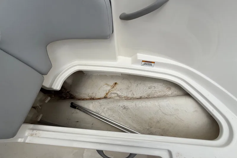Slide: The Image of An open storage compartment inside a 2024 Bayliner Element M17 boat. - 30