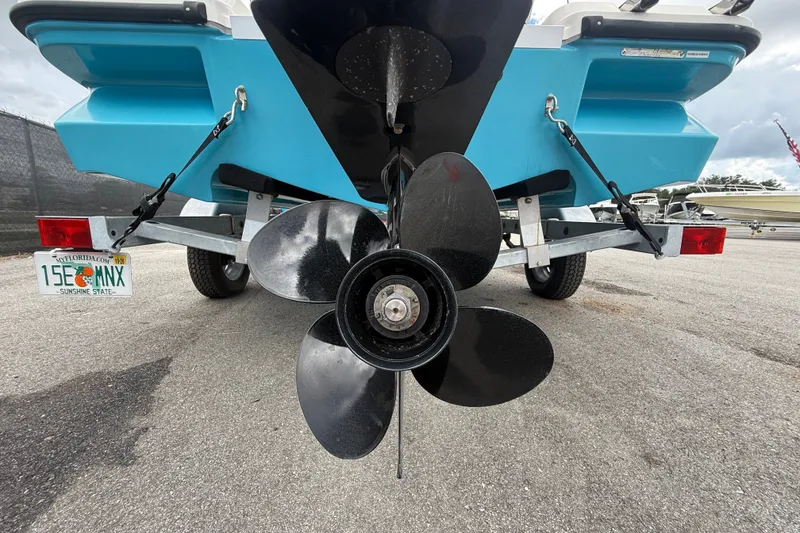 Slide: The Image of Rear view of 2024 Bayliner Element M17 boat on trailer, showcasing propeller and Florida license plate. - 6