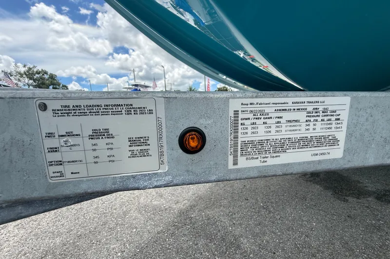 Slide: The Image of Trailer information labels on a 2024 Bayliner Element M17, showing tire and loading details. - 50