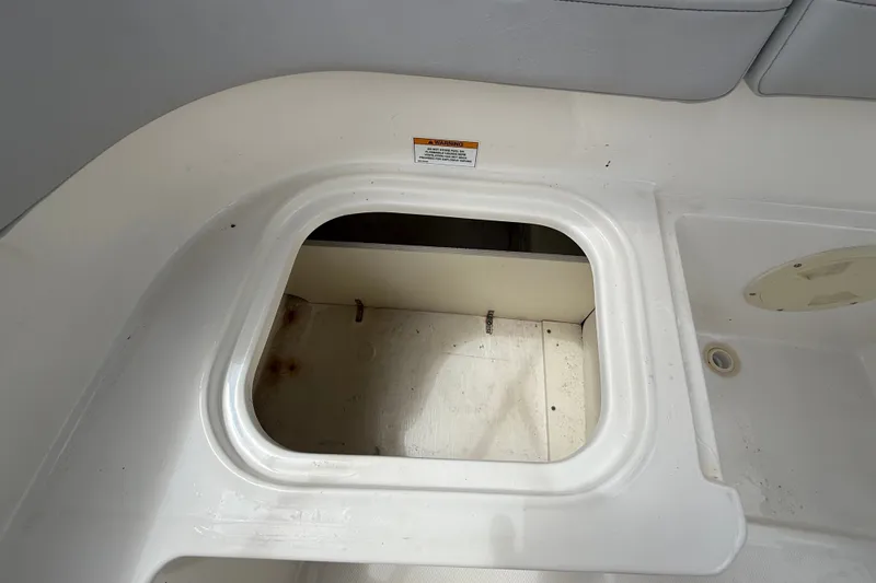 Slide: The Image of 2024 Bayliner Element M17 boat storage compartment with open hatch, showcasing interior space. - 42