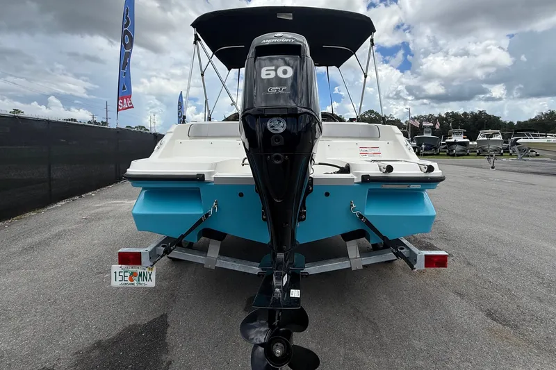 Slide: The Image of 2024 Bayliner Element M17 with outboard motor, on a trailer, under a cloudy sky. - 5