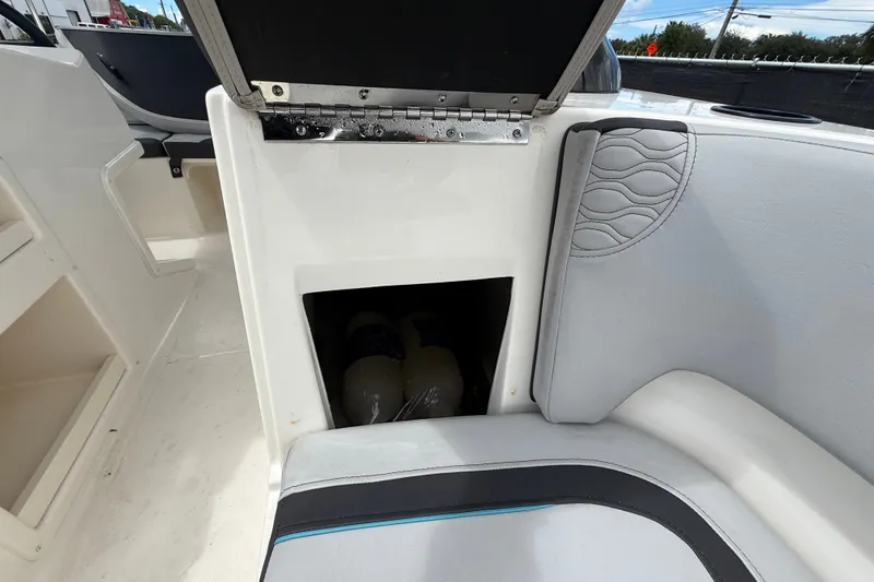 Slide: The Image of 2024 Bayliner Element M17 boat interior storage compartment with open hatch. - 38