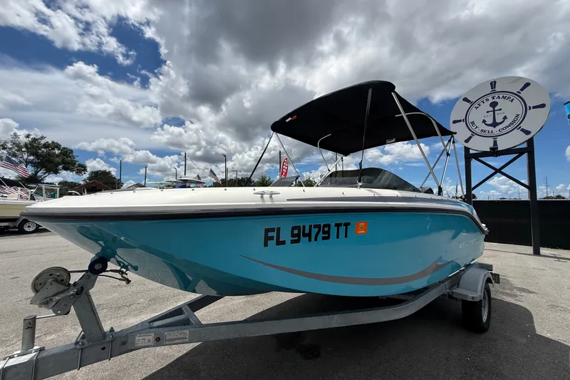 Slide: The Image of 2024 Bayliner Element M17 boat on trailer under cloudy sky. - 11