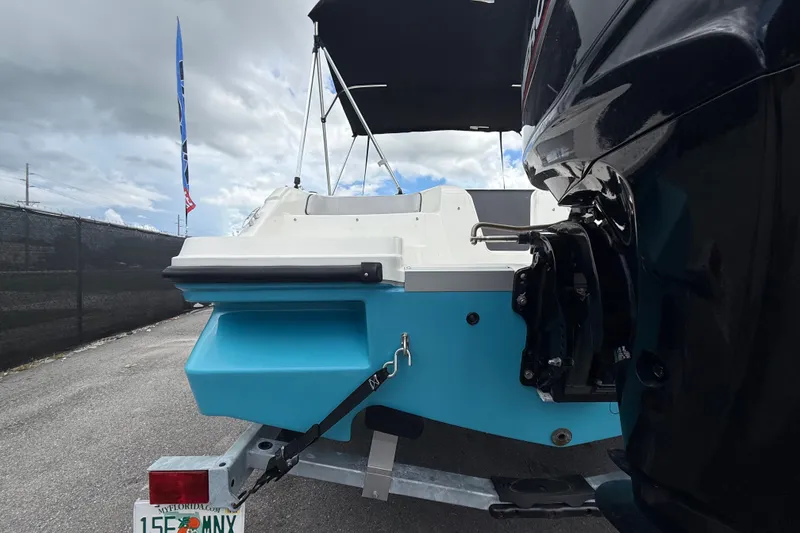 Slide: The Image of 2024 Bayliner Element M17 boat on trailer, rear view with blue hull. - 7