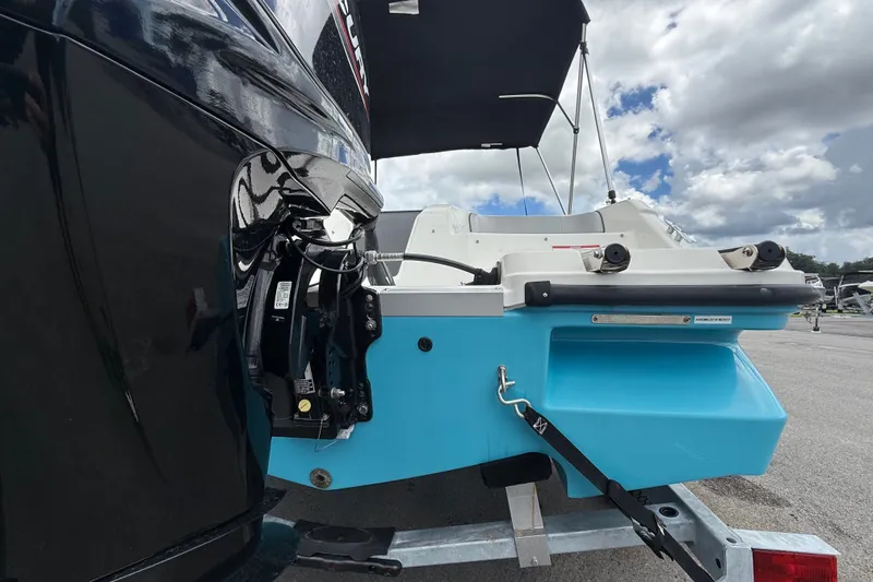 Slide: The Image of 2024 Bayliner Element M17 boat rear view with outboard motor, parked on trailer. - 4
