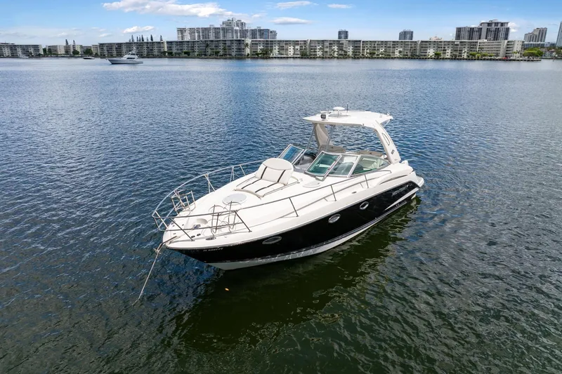 Slide: The Image of 2014 Monterey 320 Sport Yacht on calm water with cityscape background. - 4