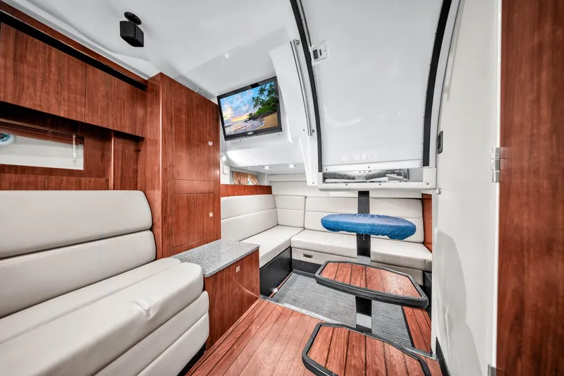 Slide: The Image of Luxurious interior of 2014 Monterey 320 Sport Yacht with modern seating and wood accents. - 33
