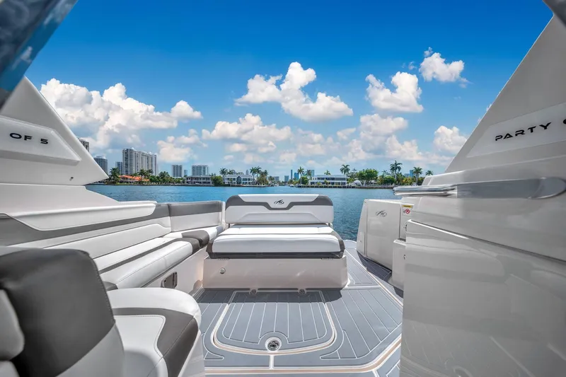 Slide: The Image of 2014 Monterey 320 Sport Yacht interior with luxurious seating, overlooking a scenic waterfront. - 17