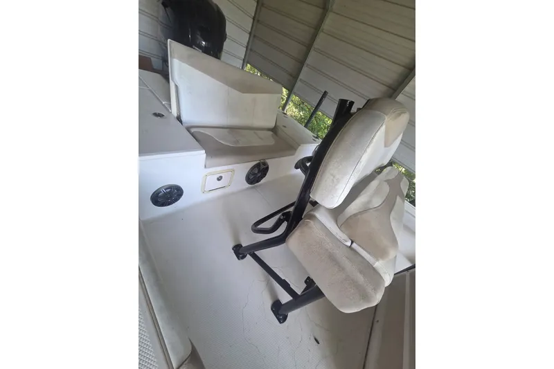 Slide: The Image of 2019 Robalo 226 Cayman boat interior with cushioned seating and storage compartments. - 11