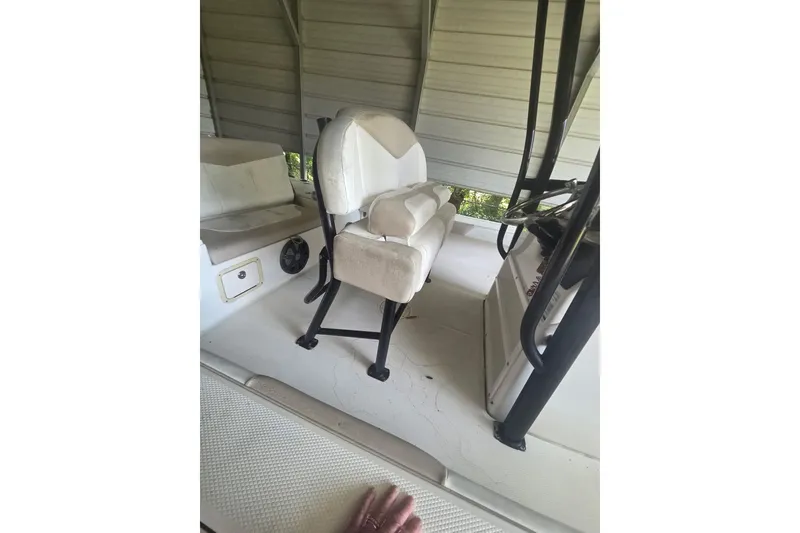 Slide: The Image of 2019 Robalo 226 Cayman boat interior with seating and steering console. - 12